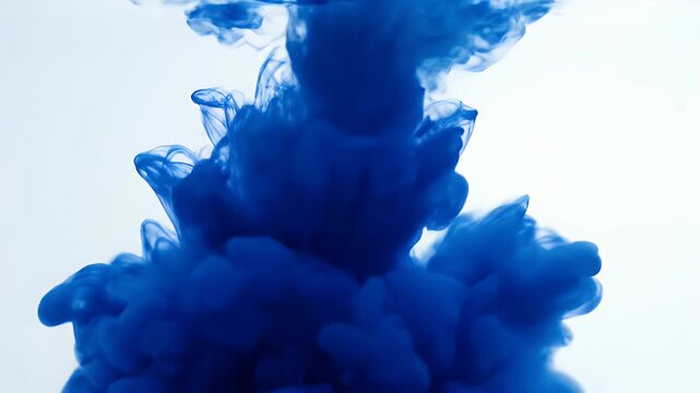 Abstract Blue Ink Cloud Dissolving in Water Slow Motion.