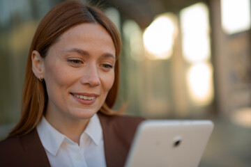 Professional woman smiling looking at digital tablet