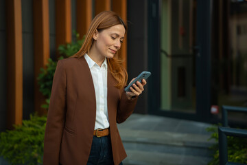 Professional woman checking mobile phone in urban setting