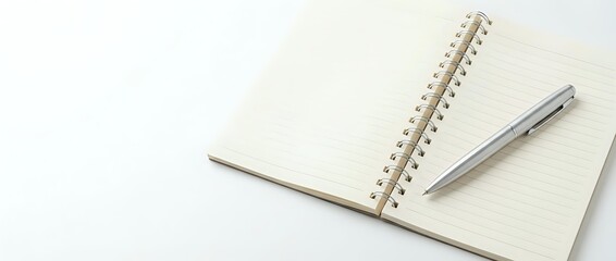 Naklejka premium Open spiral notebook with blank pages and silver pen on white background for office work and note taking.