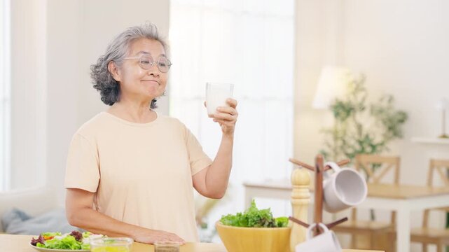 Senior woman eating healthy food and drinking fresh milk at home, elderly nutrition and balanced diet concept, wellness and active aging lifestyle with natural ingredients and healthy daily routine