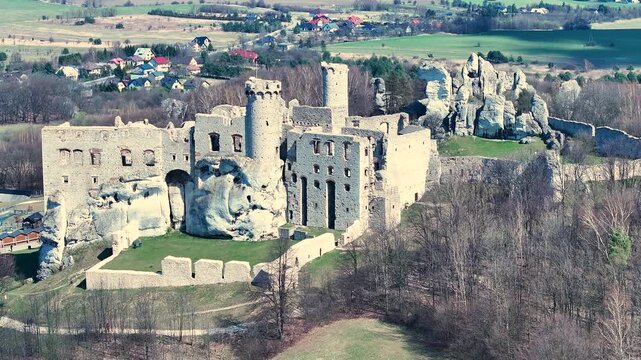 Aerial rural Poland Zamek Ogrodzieniec castle circle 3. Ruins of medieval castle south Poland. Original stronghold from 11th century, stone castle built in13th century. Rocky mountain top.