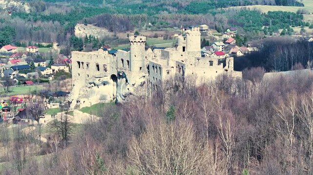 Aerial rural Poland Zamek Ogrodzieniec castle circle 1. Ruins of medieval castle south Poland. Original stronghold from 11th century, stone castle built in13th century. Rocky mountain top.