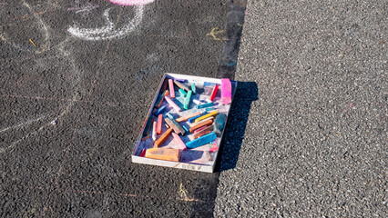 Background of box of colorful chalks and some lines of drawing. Chalk and black board are traditional and educational equipment. They are now being replaced by computer, creativity is limited © Minty