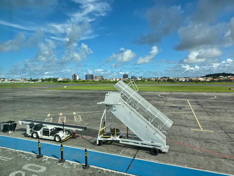 Mobile boarding stairs and airport service vehicle on apron at Jorge Amado Airport in Ilheus Bahia