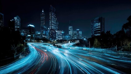 Fototapeta premium Cityscape at Night with Illuminated Roads and Buildings