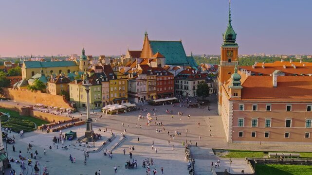 afternoon video of Old Town Warsaw in Poland with Castle Plaza filled with tourists and visitors and old architecture of Old Town 