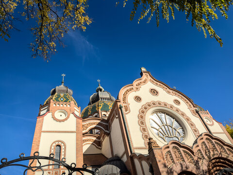 Low angle view of Subotica Synagogue in Serbia, showing its ornate facade, domes and decorative details. Also known as Jakab and Komor Synagogue, it is a symbol of judaism and a landmark of Subotica.