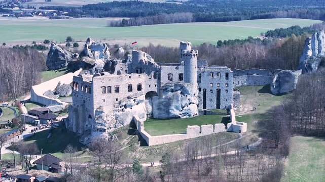 Aerial Poland Zamek Ogrodzieniec castle mountain pull 2. Ruins of medieval castle south Poland. Original stronghold from 11th century, stone castle built in13th century. Rocky mountain top.