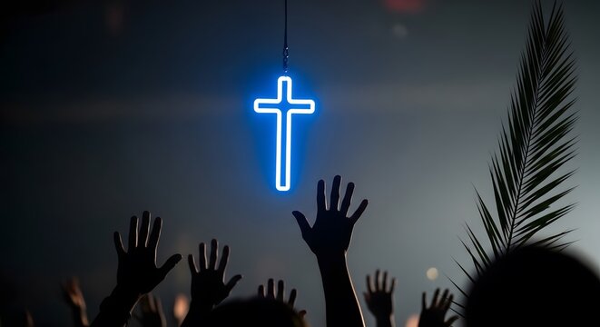 Worshipful hands reach towards a glowing neon cross in a dark religious gathering