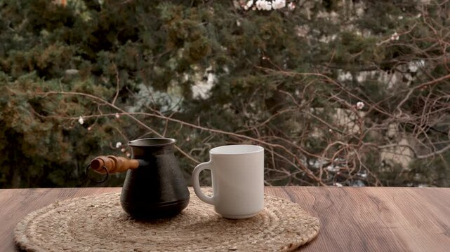 Turkish cezve and white mug on wooden table 4k copy space