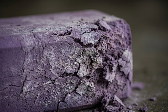Close-up of an EVA foam yoga block crumbling from severe UV degradation
