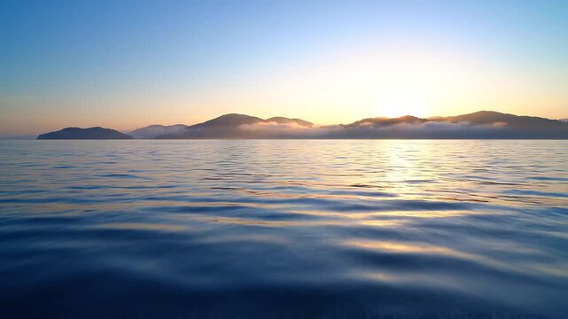 Tranquil deep blue ocean surface with subtle ripples and distant misty islands for serene seascapes