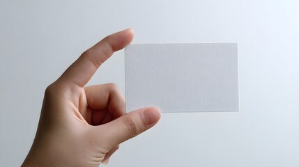 Obraz premium Hand holding transparent blank card isolated on white background.