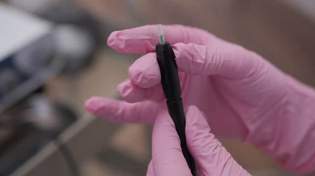 Trichologist preparing scalp mesotherapy dermapen for treatment