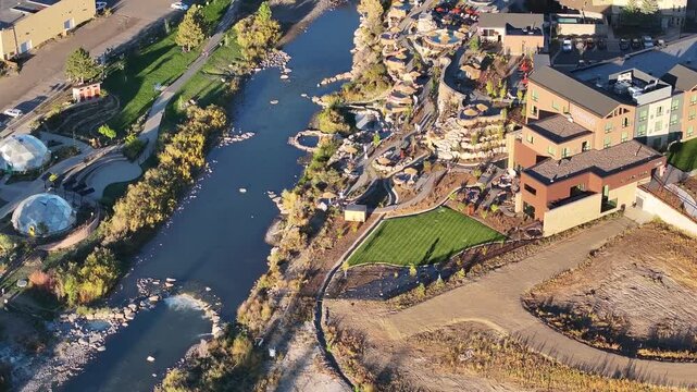 Aerial view of San Juan River and hot springs resort in Pagosa Springs, Colorado fall landscapes capturing autumn colors and natural scenery of San Juan Mountains at golden hour sunset - 4K Drone