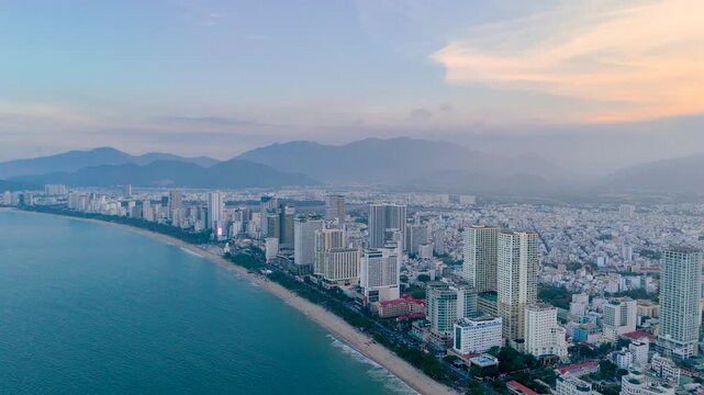 Central beach overlooking panoramic aerial view city evening on the coast of Southeast Asia in the evening at dawn sunrise Nha Trang