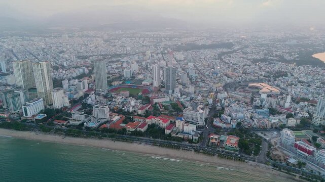 Central beach overlooking panoramic aerial view city evening on the coast of Southeast Asia in the evening at dawn sunrise Nha Trang