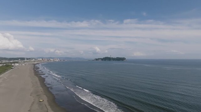 Aerial drone view of Enoshima Island and Shonan coastline in Kanagawa Japan, ocean waves and coastal city landscape