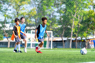 Obraz premium African American boy run straight to the soccer ball and prepare to kick or shoot the ball in the field with day light.