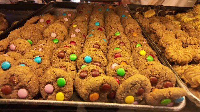 Rows of delicious colorful cookies arranged on trays ready for sale.