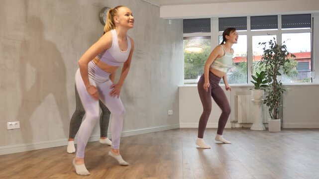 Young woman performs twerking moves in fitness center