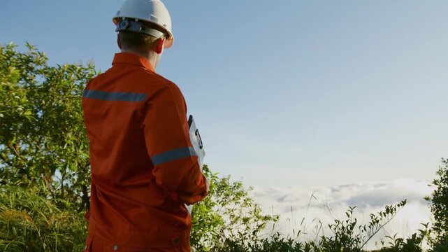 Environmental Engineer Inspecting Sustainable Construction Site on Mountain Peak