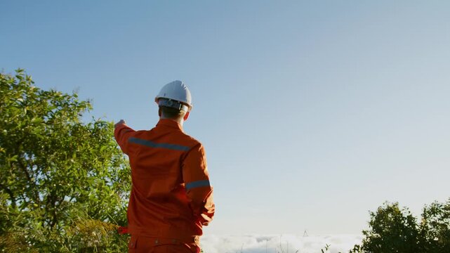 Environmental Engineer Inspecting Sustainable Construction Site on Mountain Peak