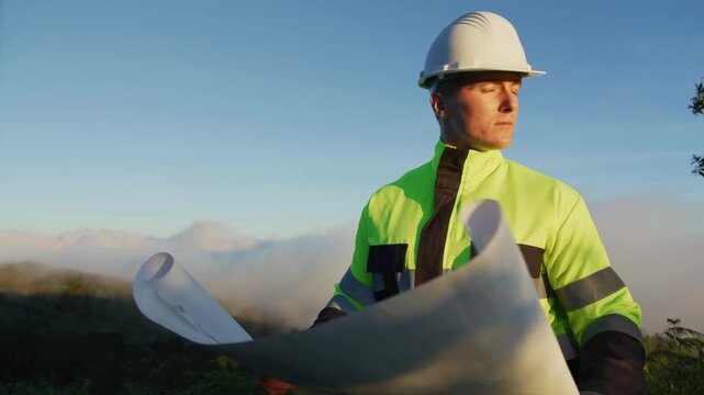 Environmental Engineer Inspecting Sustainable Construction Site on Mountain Peak