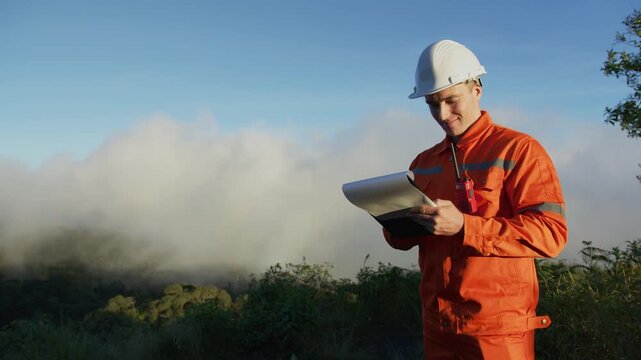 Environmental Engineer Inspecting Sustainable Construction Site on Mountain Peak