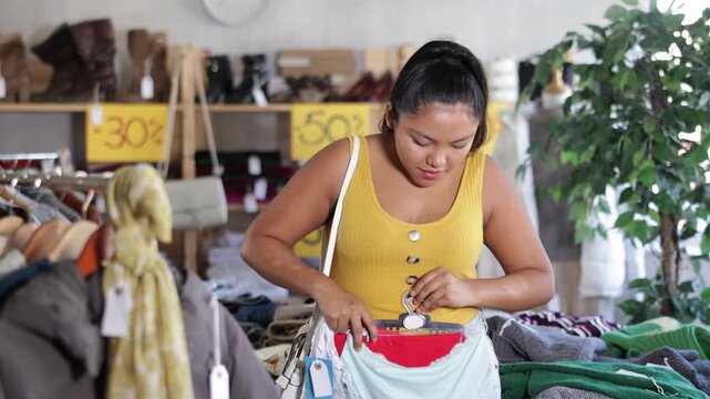Girl at trading floor pick out and buying panties. Off line clothing store from retailer. Style and fashion look, modern trends. Designer clothing store, vintage fashion, limited edition