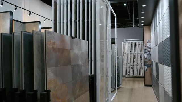 Element of Modern tile showroom interior with large ceramic and porcelain slabs displayed in vertical racks