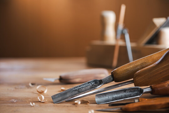 Woodworking tools on wooden workbench in carpentry workshop. Joinery and craft carving tools for wood processing.