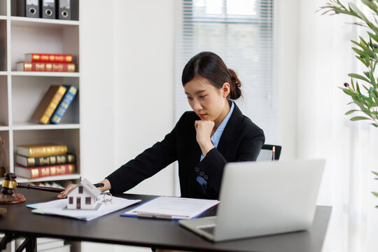 Asian woman lawyer analyzing real estate legal contract