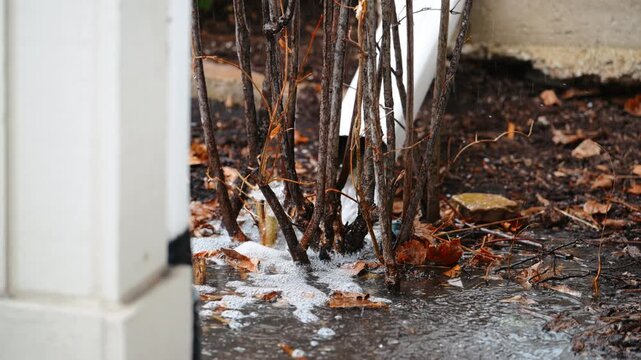 Heavy rainwater flowing from a roof drain during storm