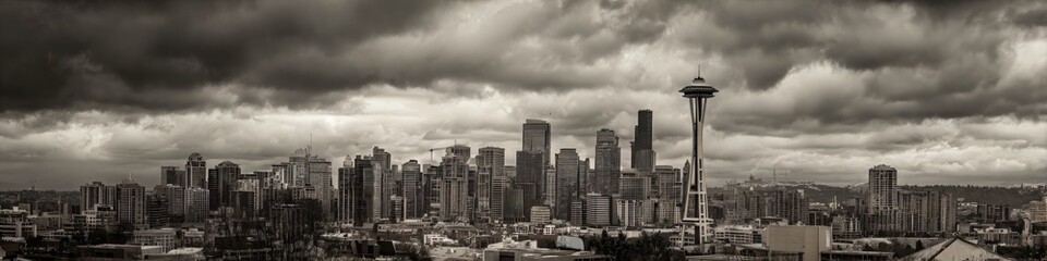Fototapeta premium Seattle Skyline Panorama: A stunning panoramic view of Seattle's iconic skyline under a dramatic, cloud-filled sky, capturing the city's urban grandeur and unique architectural blend.