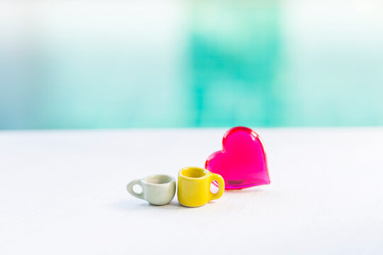 Tea and coffee cup with red heart over blurred background, valentine background idea, love and romance, togetherness
