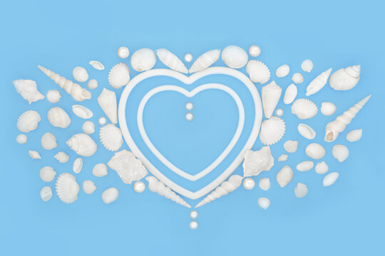 Heart shape seashell and pearl romantic wreath on blue background with white frames. Natural marine life symbol of love for Valentines, anniversary or birthday greeting card.