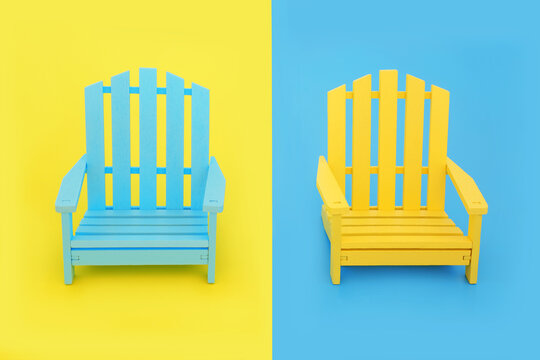 Fun wooden slatted chairs in vivid yellow and blue contrast colors. Abstract design for indoor or outdoor beach, garden or patio furniture seating.