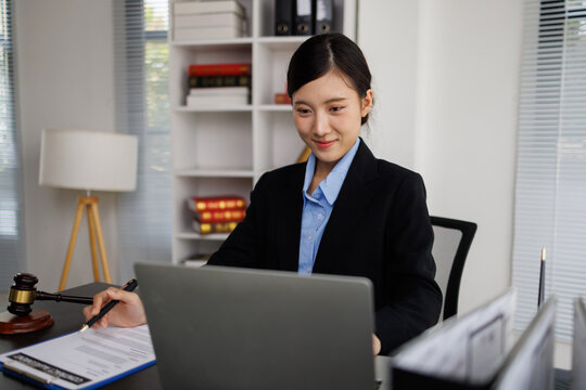 Female lawyer working on legal documents using laptop