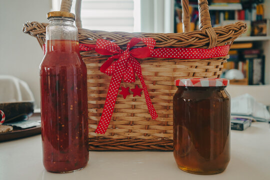 Tomato juice and jars of jam on the table