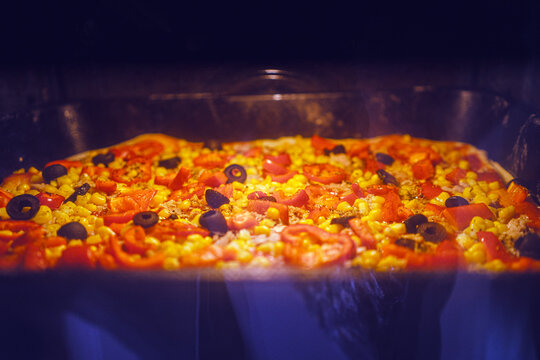 Homemade pizza with vegetables and fish