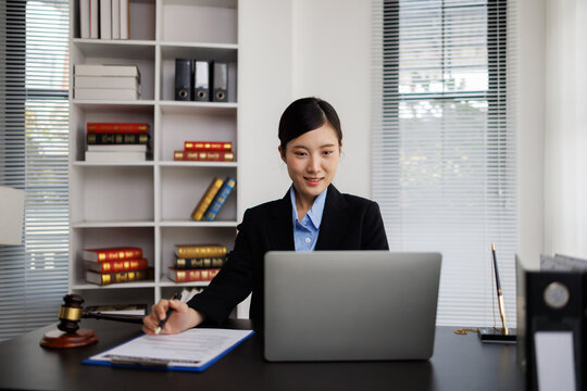 Young female lawyer working on legal documents in office