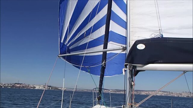 Sailing under a clear blue sky with vibrant flags waving