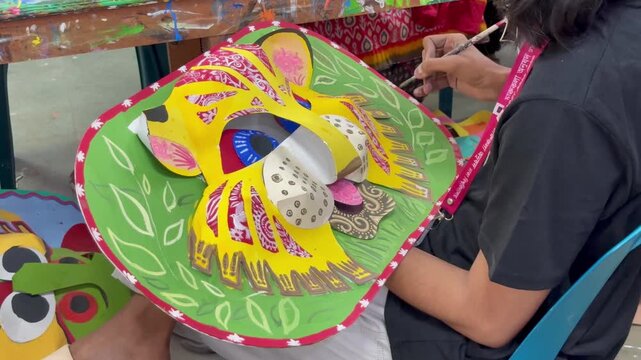 Bangladeshi Artisan Hand Painting Colorful Folk Mask for Bengali New Year Festival in Dhaka, Bangladesh on 12 April, 2025