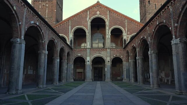 The courtyard and the facade of Sant'Ambrogio (meaning Saint Ambrogio) romanesque cathedral, Arches on both sides.Milan, Italy. 