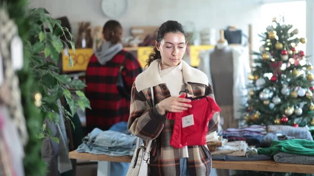 Armenian girl near showcase pick out buying traditional red lace panties. Off line clothing store from retailer. Style fashion look, modern trends. Discount X mass holiday season, promotional offers