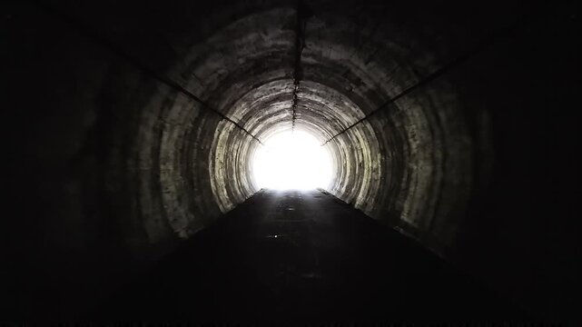 Journey into the light a captivating view from inside a dark tunnel, beckoning towards a bright future