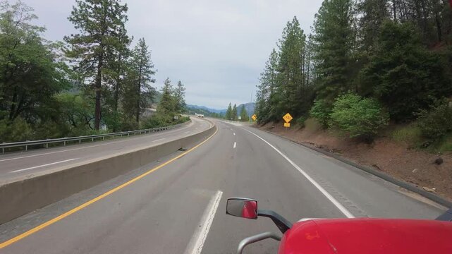 Big rig truck POV driving on a concrete highway bridge over a large lake