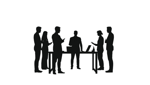 Business professionals stand around a table with laptops, engaging in a productive discussion or informal.